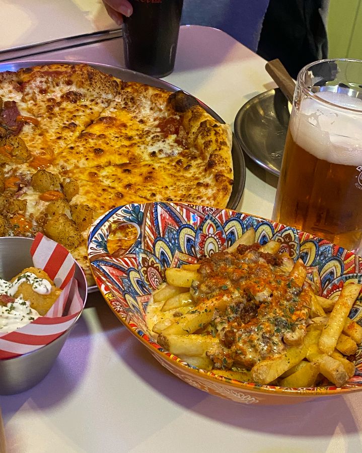 피자와 감자튀김, 맥주가 놓인 테이블