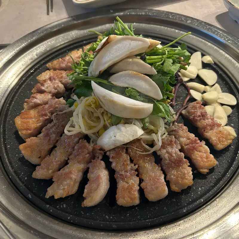 잘 구워진 꽃삼겹살, 목살, 버섯, 미나리