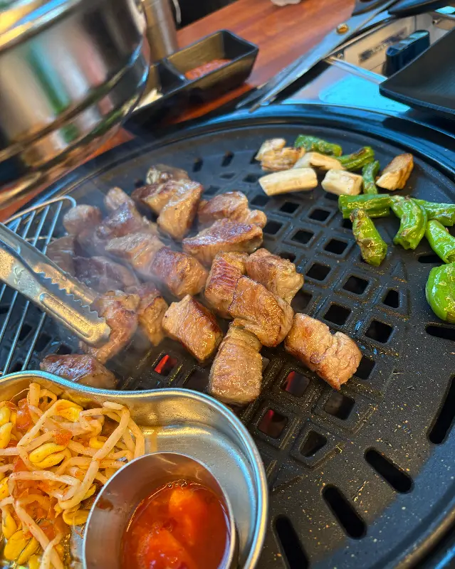 불판 위에서 맛있게 익어가는 돼지 고기