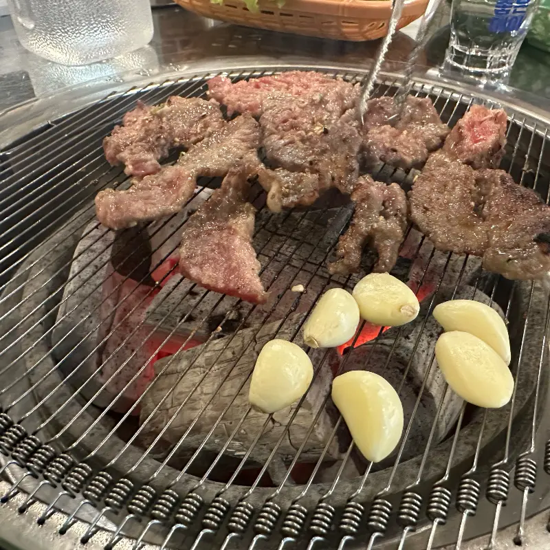숯불 위에서 구워지는 갈비살과 마늘