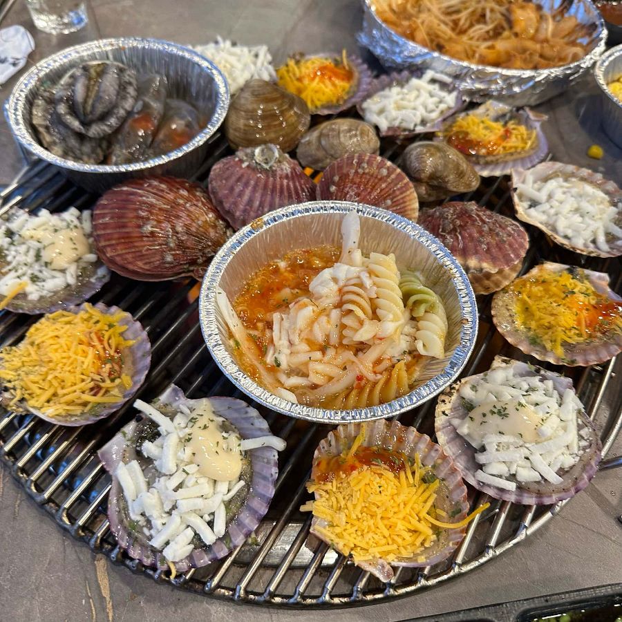 불판 위에서 익어가는 다양한 조개들