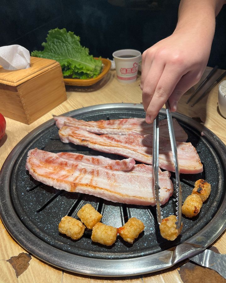 쌈 채소와 함께 구워진 삼겹살