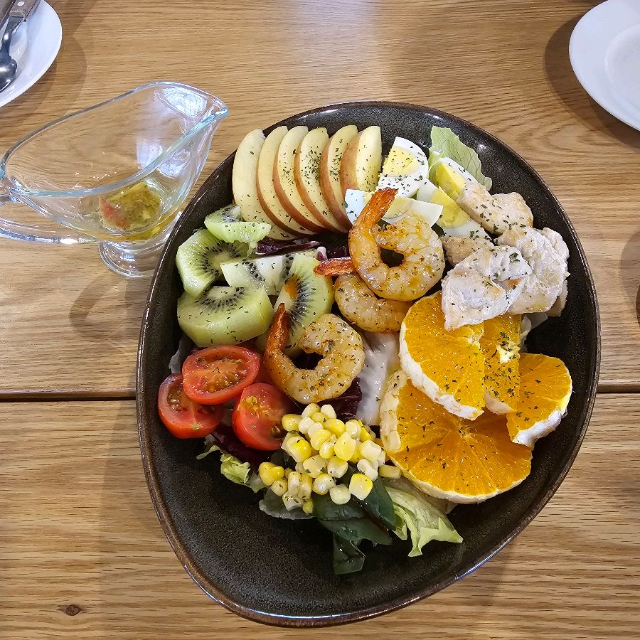 신선한 채소와 과일, 닭가슴살의 조화가 돋보이는 샐러드