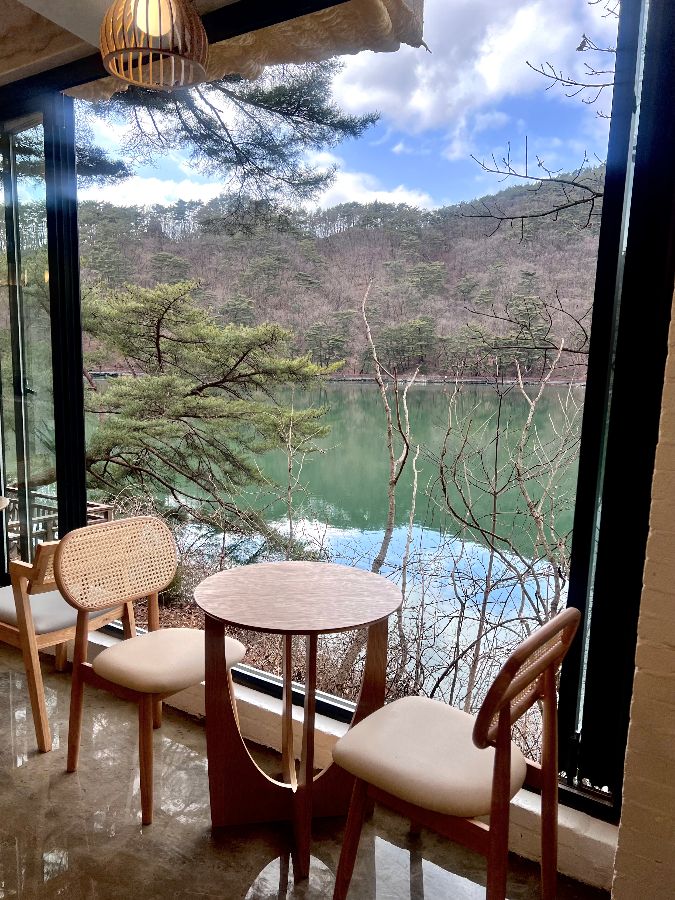 창밖으로 보이는 잔잔한 호수 뷰와 테이블