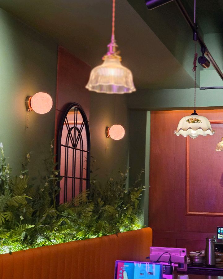 단성무이 동래점의 은은한 조명과 플랜테리어가 돋보이는 내부