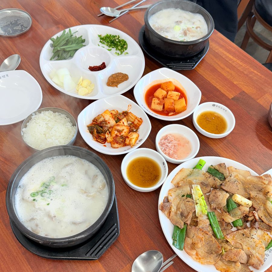 돌탄순댓국 안동점의 푸짐한 상차림, 순대국밥과 석쇠구이, 다양한 곁들임이 완벽한 조화를 이룬다.