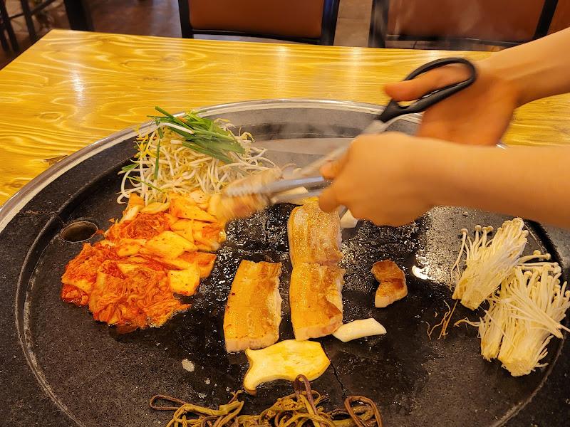 직원분이 삼겹살을 먹기 좋은 크기로 잘라주는 모습