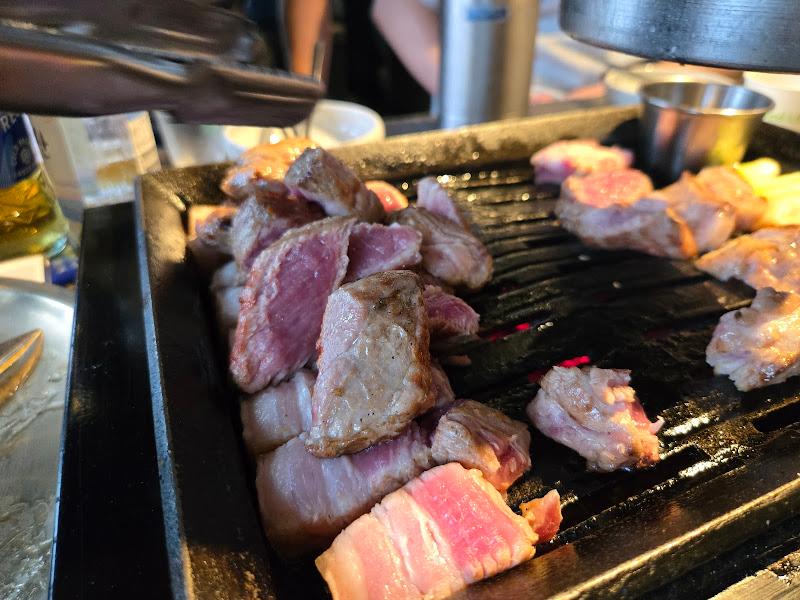 불판 위에서 맛있게 구워지고 있는 흑돼지