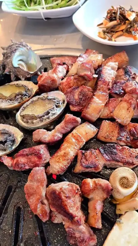 잘 구워진 흑돼지 오겹살과 전복