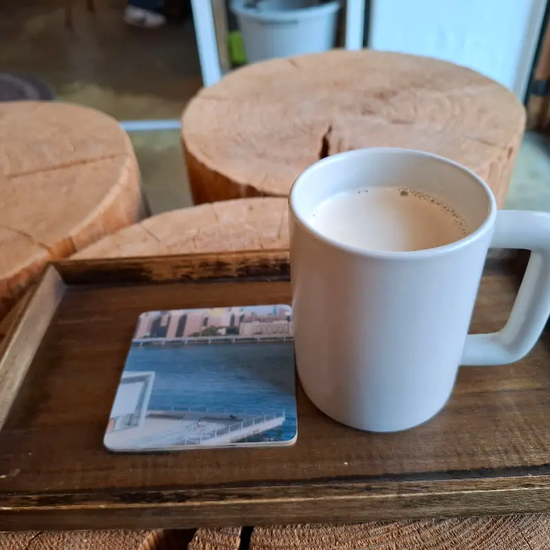 쟁반 위에 놓인 밀크티와 코스터