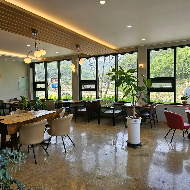 넓은 테이블과 편안한 의자가 놓인 카페 내부