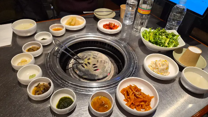 다양한 곁들임 찬들이 테이블을 가득 채운 모습