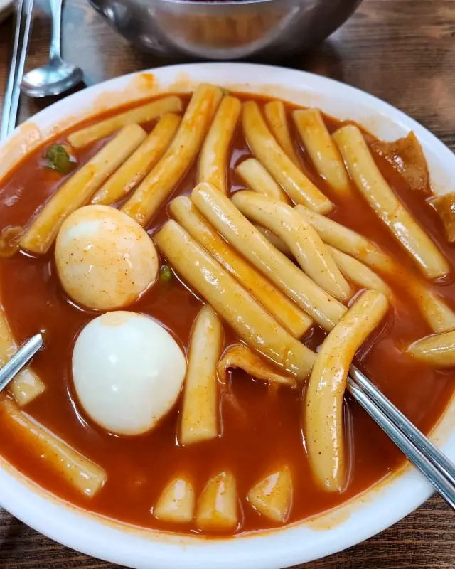 떡볶이 떡을 젓가락으로 집어 올리는 모습