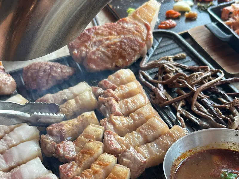 숯불 위에서 노릇하게 익어가는 흑돼지 오겹살