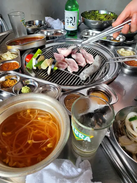 삼겹살과 함께 다양한 반찬이 놓인 테이블