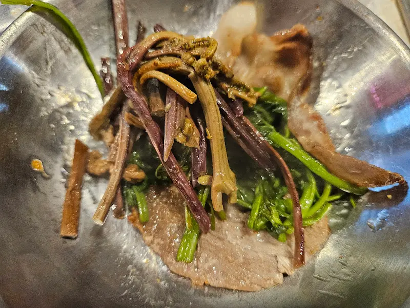 미나리와 냉동 삼겹살을 함께 먹는 모습