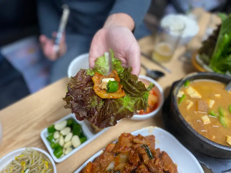 싱싱한 쌈 채소에 제육볶음을 싸서 한 입