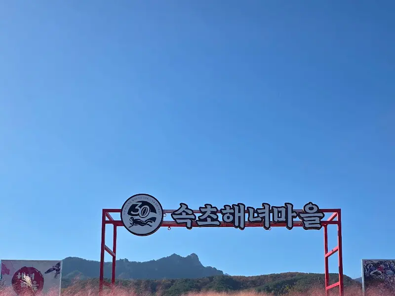 속초해녀마을 간판과 설악산 풍경