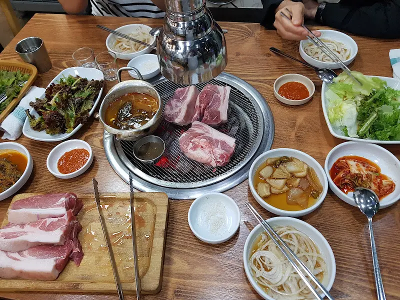 숯불 위에서 맛있게 구워지는 갈비살과 흑돼지