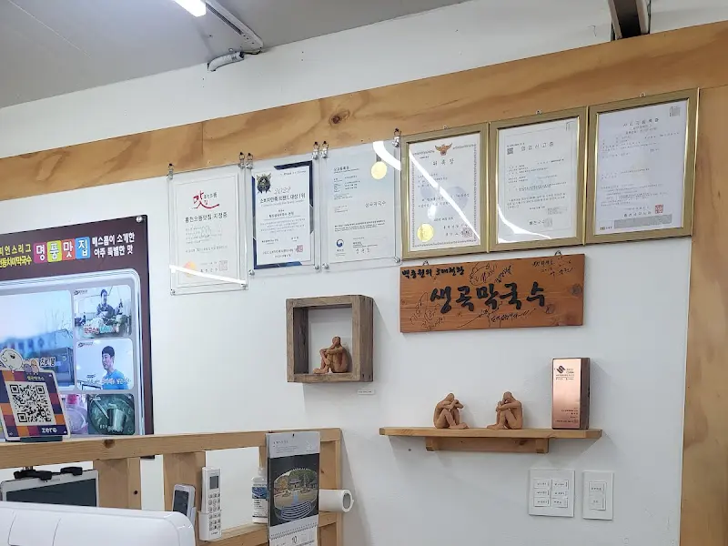 벽에 걸린 각종 인증서와 백종원의 3대 천왕 출연 사진