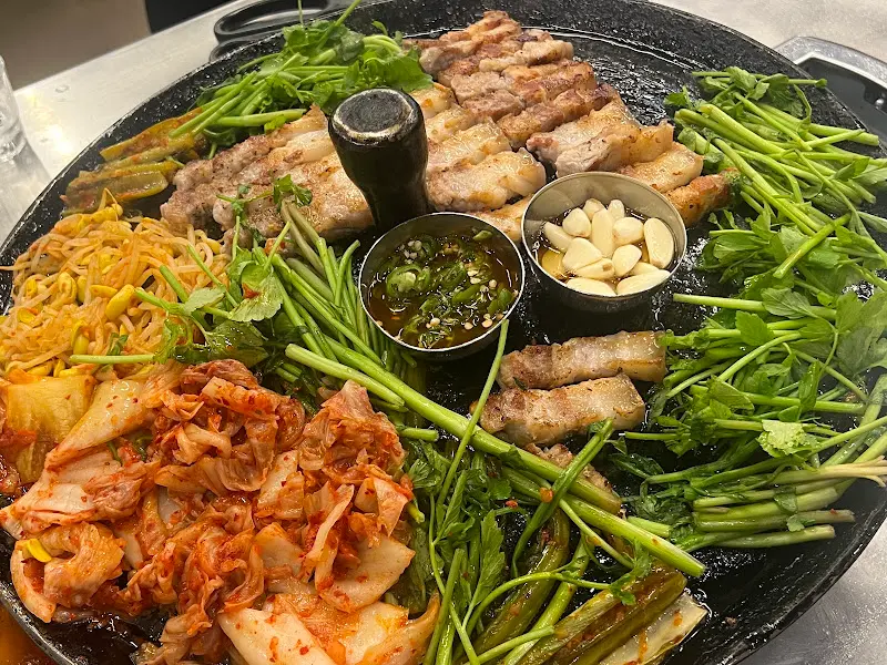 불판 위의 삼겹살과 곁들임