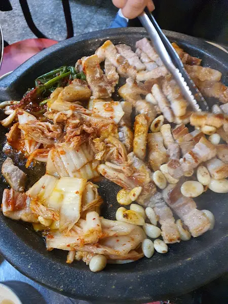 삼겹살과 김치, 마늘을 함께 굽는 모습