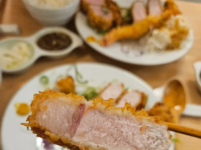 젓가락으로 집어올린 등심카츠 단면