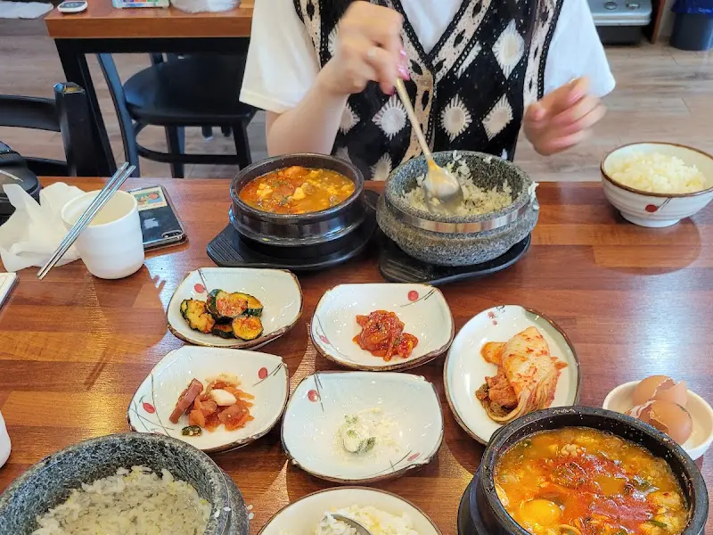 순두부 찌개와 돌솥밥을 먹고 있는 모습