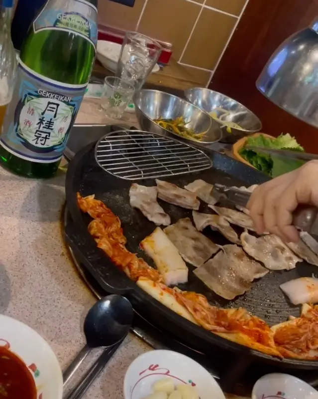 잘 구워진 삼겹살 한 점을 소주와 함께