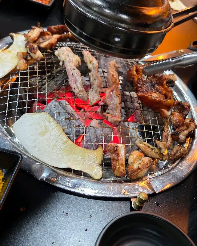 숯불 위에서 맛있게 익어가는 닭갈비와 버섯