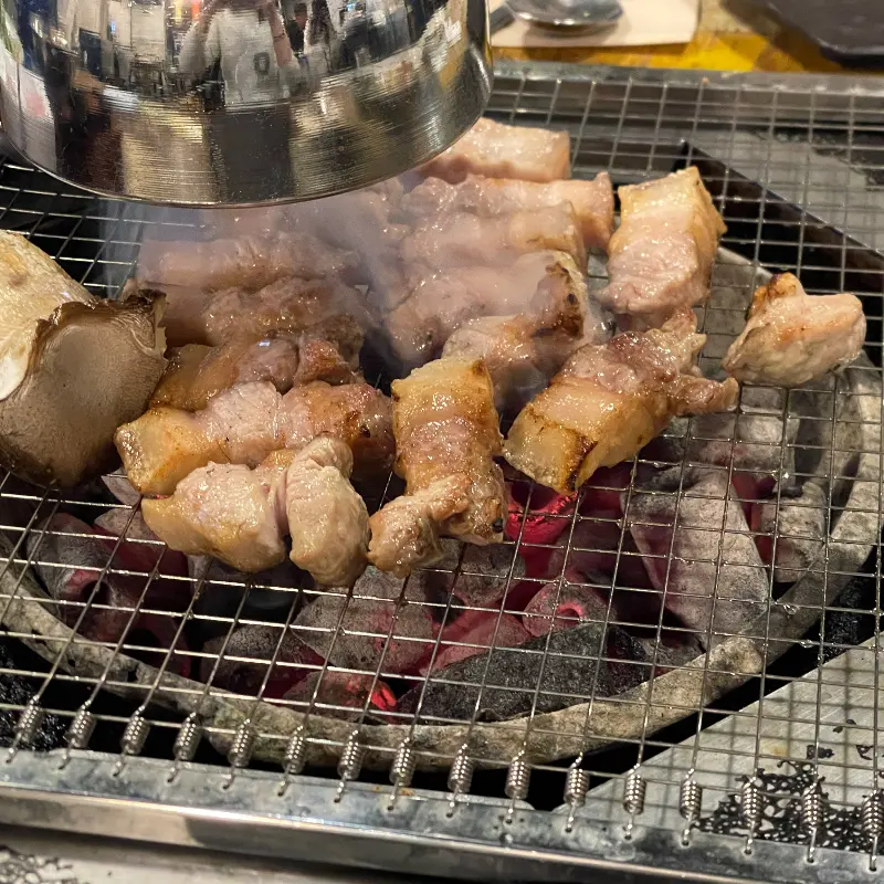 잘 익은 오겹살이 먹기 좋은 크기로 잘려 불판 위에 놓여 있는 모습