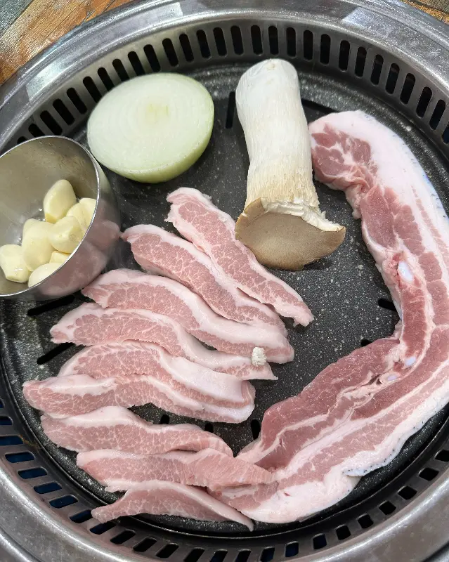 불판 위에서 익어가는 돼지고기의 모습