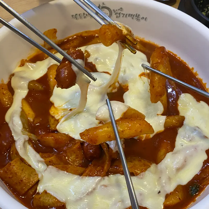 젓가락으로 떡볶이를 들어올리는 모습