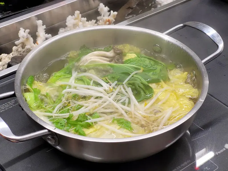 육수에 채소를 넣어 끓이는 모습