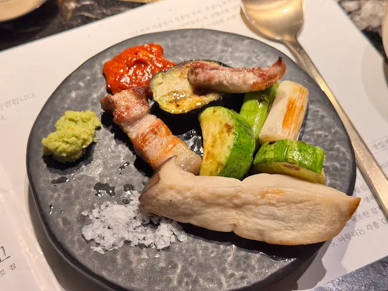 구운 고기와 야채를 소스에 찍어 먹는 모습