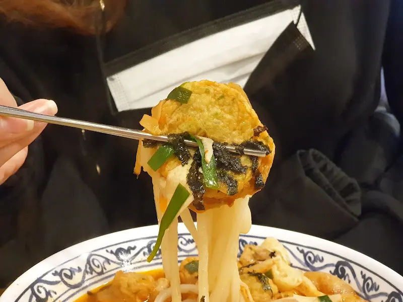 젓가락으로 집어 올린 어묵우동