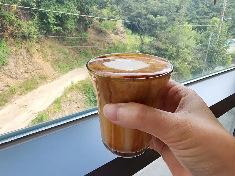 창밖 풍경을 바라보며 즐기는 따뜻한 라떼