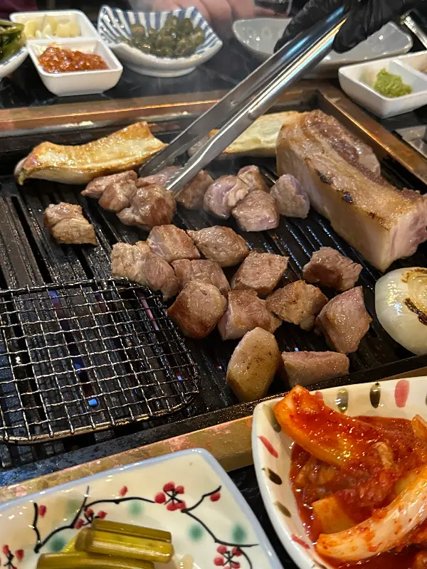 잘 구워진 삼겹살과 다양한 밑반찬