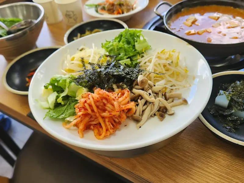 놋쇠 그릇에 담긴 보리밥과 여러가지 나물들