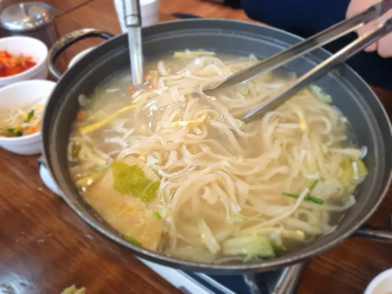 만두전골에 칼국수를 넣어 먹는 모습