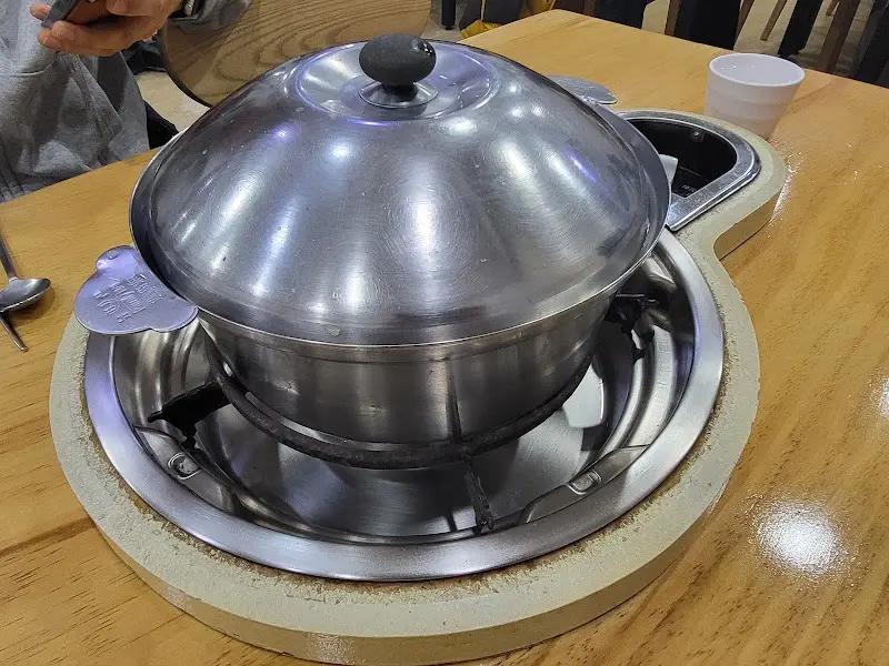 테이블 위 버너에 올려진 해물칼국수 냄비