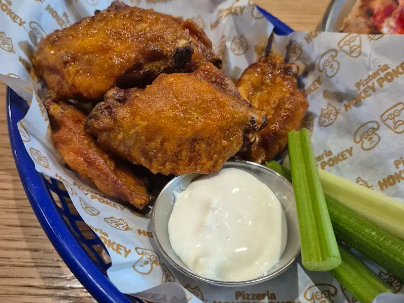 버팔로 윙과 샐러리, 소스가 함께 담겨 있는 모습