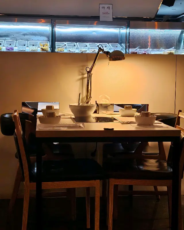 테이블 위에는 개인용 식기와 냄비가 가지런히 놓여 있다.