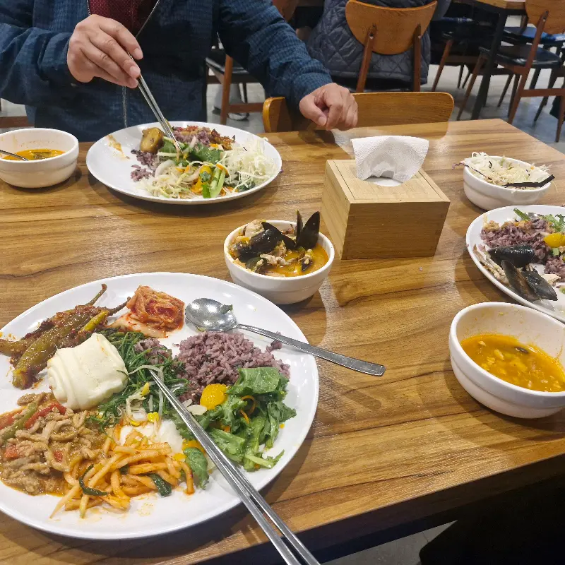 뷔페식으로 차려진 음식들을 담아 먹음직스럽게 차려진 테이블