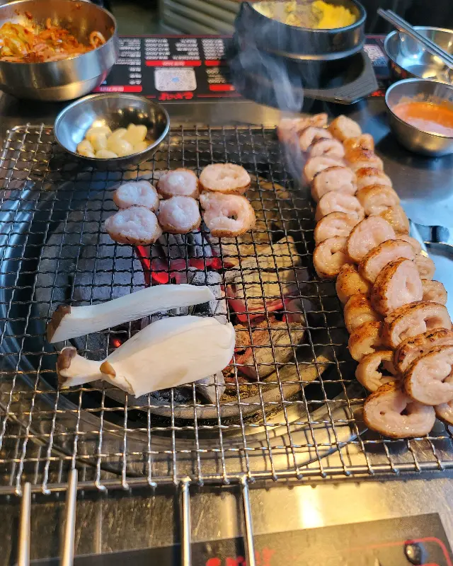 초벌되어 나온 막창과 삼겹살, 숯불 위에서 구워지는 모습