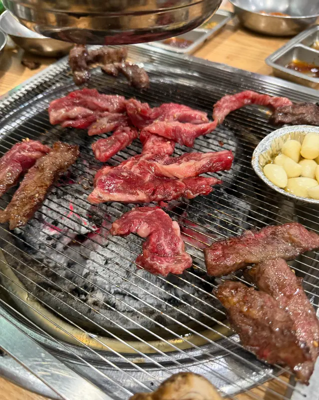 숯불 위에서 구워지는 소갈비살과 전복