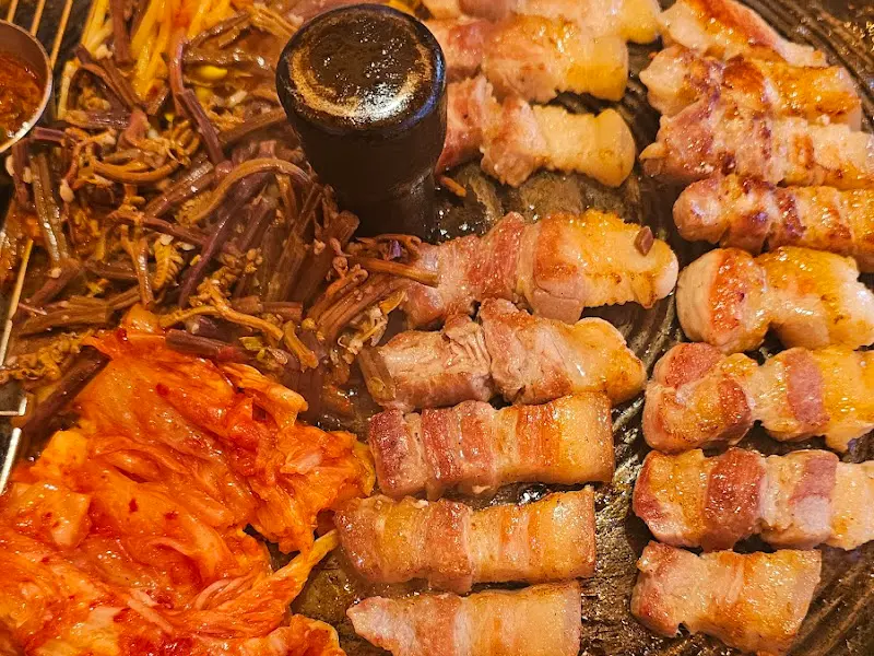 노릇하게 구워진 돼지 삼겹살과 김치