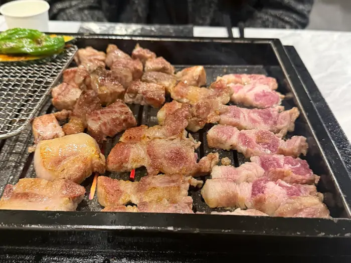 노릇노릇하게 잘 익은 흑돼지 조각들이 불판 가득 채워져 있어요