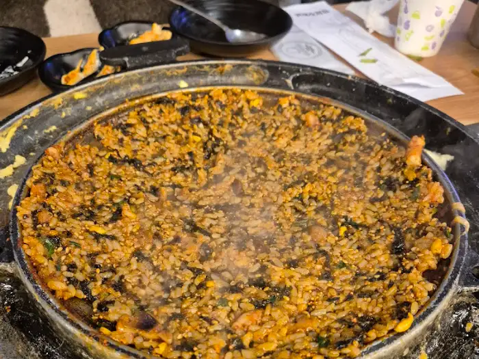 철판에 볶아지고 있는 볶음밥의 모습. 김가루와 밥이 어우러져 먹음직스럽다.