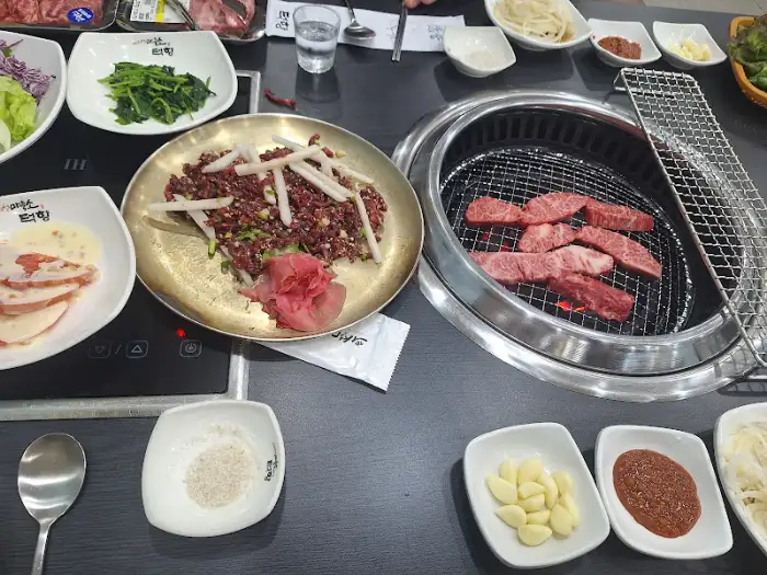 불판 위 소고기와 반찬들